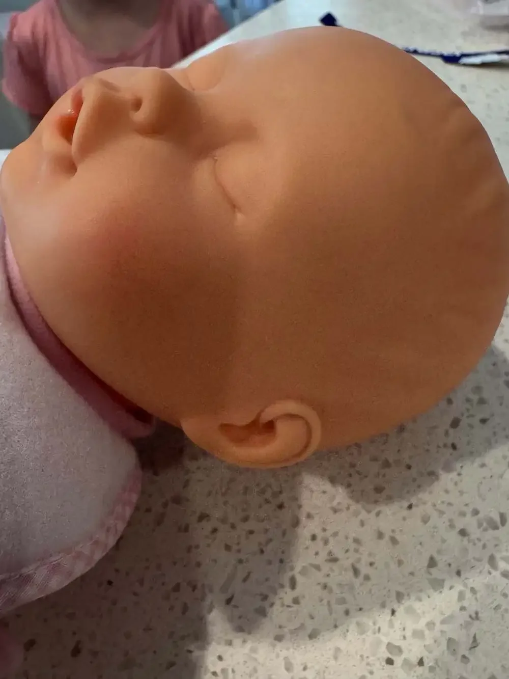 Soft Body Baby Doll with Vinyl Head and Pink Animal Applique Bib